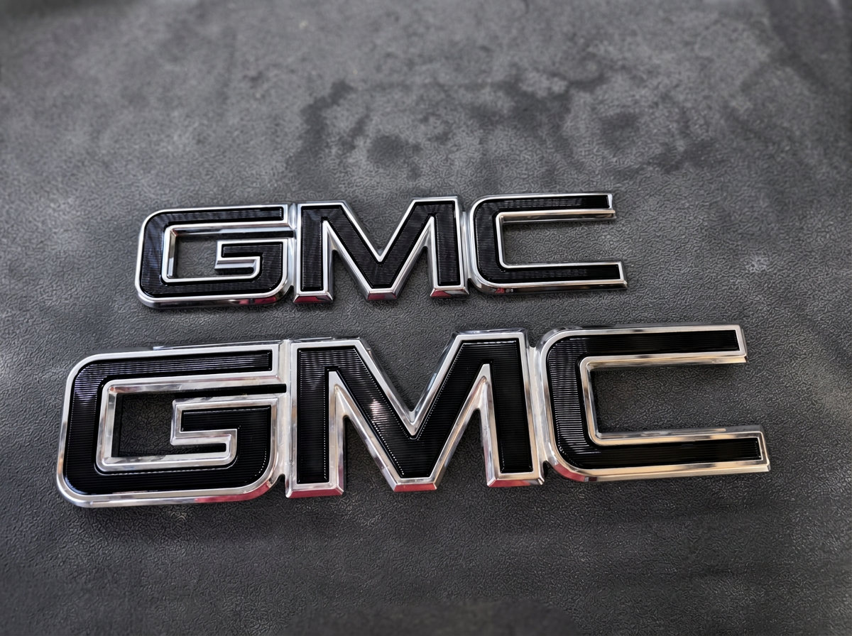 Custom-painted GMC badges finished by JC PaintWRKX